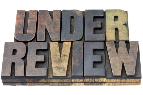 A picture of vintage letterpress wood type that says Under Review